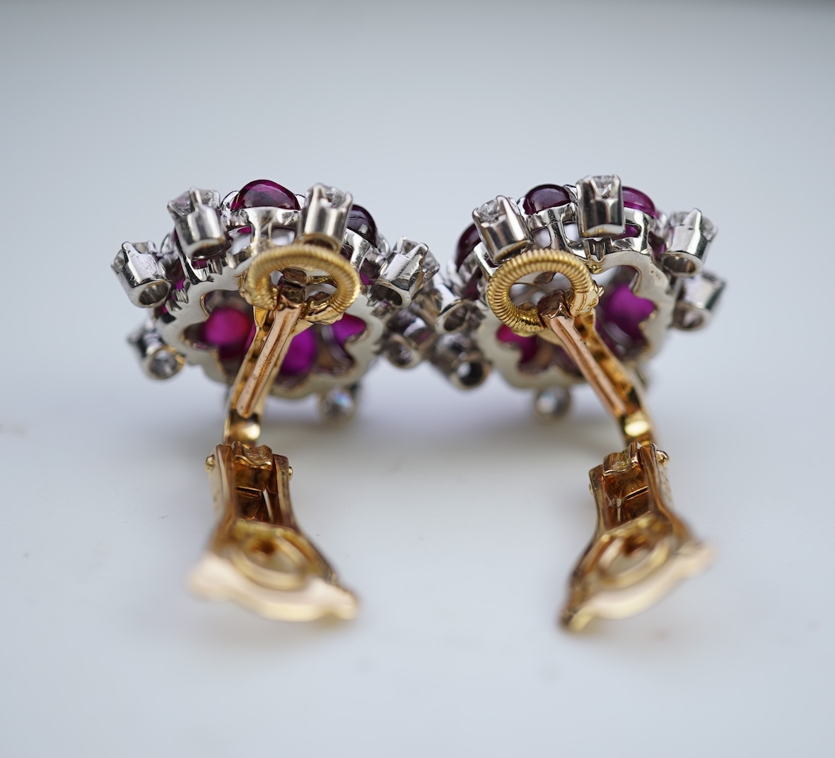 A pair of ruby and diamond ear clips, mid 20th century